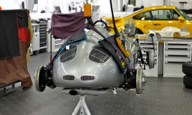 A F1 car is being serviced in the garage located below the archive.